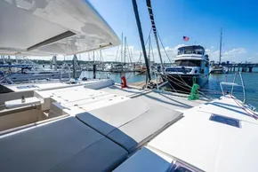 Luxurious Leopard 50 catamaran docked at marina, sunny day, 2022 model.