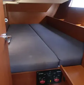Interior cabin of 2019 Beneteau Oceanis 41.1 sailboat with bed and control panel.