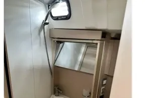 Modern bathroom in 2023 Beneteau Oceanis 51.1 yacht with compact sink and mirror.