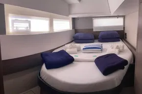 Luxurious cabin interior of 2022 Leopard 45 yacht with neatly arranged bedding.
