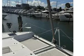 Deck view of a 2025 Leopard 46 catamaran docked at a marina.