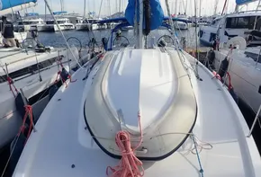 Jeanneau Sun Odyssey 440 sailboat deck with dinghy, docked in marina, 2019 model.
