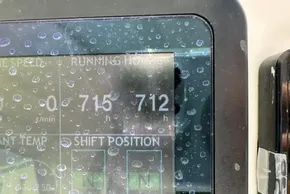 Display screen of 2025 Leopard 46 Powercat showing running hours, covered in water droplets.