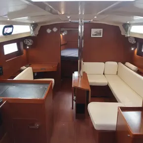 Interior of 2019 Beneteau Oceanis 41.1 yacht with wood finish and white seating.