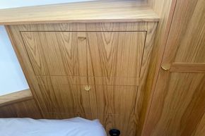 Wooden cabinetry in a 2024 Piper 12c, featuring sleek design and modern handles.