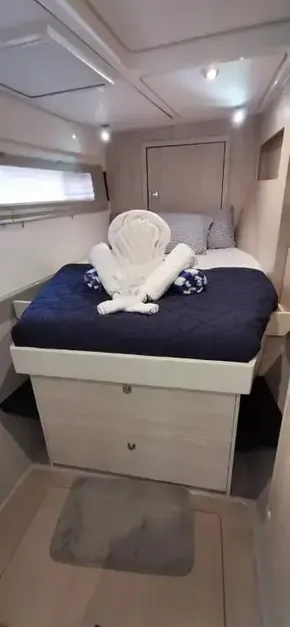 Luxurious bedroom in a 2019 Leopard 51 Powercat with elegant towel art on the bed.