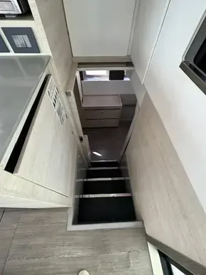 Interior of a 2020 Leopard 50 yacht, featuring modern stairs and sleek cabinetry.