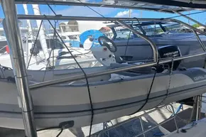 2024 Lagoon 42 catamaran with dinghy and Mercury outboard motor in marina.