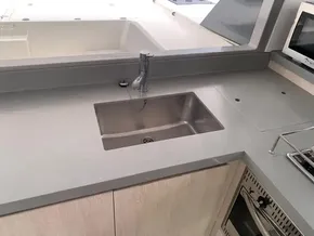 Modern kitchen sink area on a 2021 Leopard 45 yacht, featuring sleek countertops and appliances.