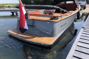 2026 Enkhuizensloep 744 Tender boat docked, featuring sleek design and wooden deck.