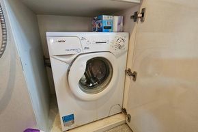 Compact washing machine in a cabinet on a 2005 Stevens 1200 Vlet boat.