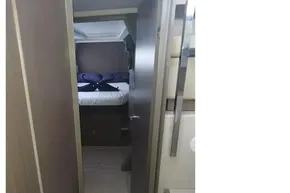 Interior cabin view of 2022 Leopard 45 yacht, featuring a cozy bedroom setup.