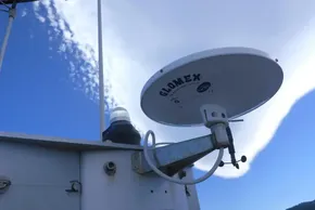 Satellite dish on 2017 Lagoon 42 boat against blue sky.