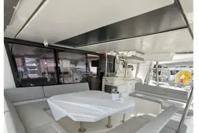 Spacious outdoor seating area on a 2020 Leopard 50 yacht with a covered dining table.