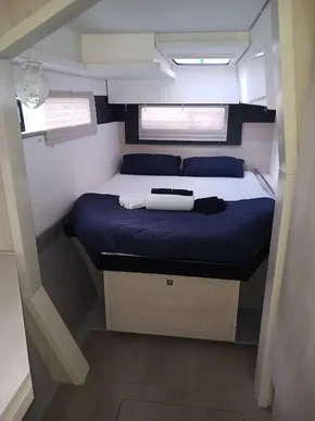 Cozy bedroom in 2021 Leopard 40 catamaran with modern design and natural light.