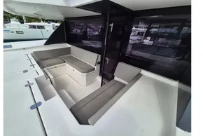 Outdoor seating area on a 2020 Leopard 45 catamaran, featuring cushioned benches and sleek design.