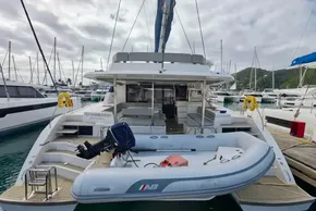 2019 Leopard 50 yacht docked with inflatable boat, surrounded by other vessels.