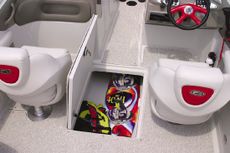 Crownline Bowrider 230 LS - An in-floor wakeboard/ski storage compartment is located beneath the windshield walk-thru area