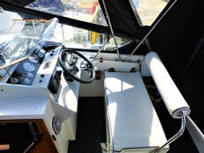 Cockpit of 1995 Aquafibre Bounty Boats 10/70 with steering wheel and seating.
