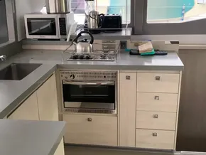 Modern kitchen in 2021 Leopard 45 yacht with appliances and sleek cabinetry.