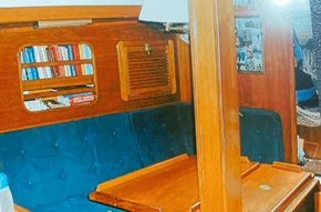 The Saloon includes storage, a port sette which expands to provide room to sleep two. It also includes a folding table at midship.