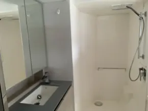 Modern bathroom in a 2020 Leopard 50 yacht, featuring a sleek sink and shower area.