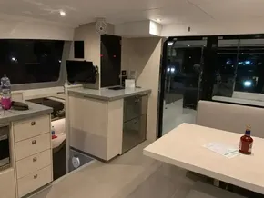 Modern interior of 2020 Leopard 40 catamaran with kitchen and dining area.