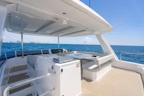 Leopard 40 Powercat 2025 yacht deck with seating, ocean view, and clear blue sky.