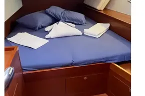 Cozy cabin interior of 2018 Beneteau Oceanis 48 with neatly arranged bedding.