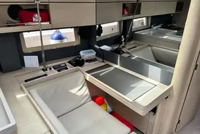 Interior of 2023 Beneteau Oceanis 51.1 yacht, featuring a modern navigation station and seating area.