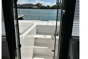 2025 Robertson and Caine Leopard 46 Powercat, view from cabin to deck, sunny waterfront.