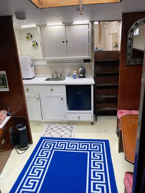 Bright well equipped galley with steps to upper deck