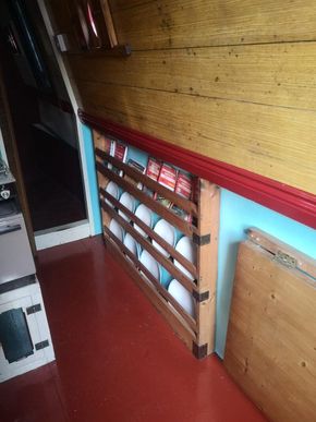 Plate rack and fold down table in front cabin