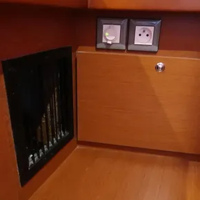 Beneteau Oceanis 51.1 2018 interior with power outlets and wooden paneling.
