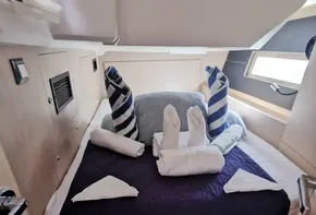Cozy cabin interior of 2020 Beneteau Oceanis 46.1 yacht with neatly arranged bedding.
