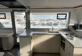 Modern kitchen interior on 2019 Leopard 45 yacht, featuring sleek design and marina view.