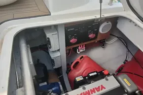 Engine compartment of 2024 Lagoon 42 catamaran with Yanmar engine and battery controls.