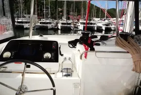Cockpit view of a 2020 Lagoon 42 catamaran docked at a marina.