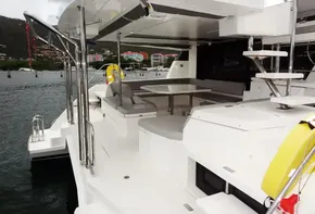 Leopard 50 yacht 2020 model, spacious deck with seating and dining area, docked in marina.