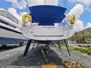 Jeanneau Sun Odyssey 410 sailboat, 2020 model, docked with blue canopy and yellow lifebuoys.