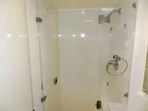 2015 Leopard 51 Powercat shower cabin with glass door and chrome fixtures.