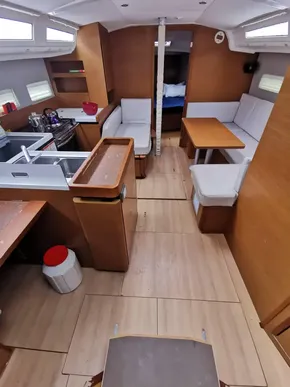 Interior of 2020 Jeanneau Sun Odyssey 410 sailboat with modern kitchen and seating area.
