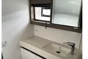 Modern bathroom in 2022 Leopard 53 Powercat yacht with sleek sink and toilet.