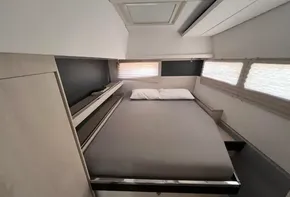 Modern bedroom interior in 2019 Leopard 45 catamaran with double bed and windows.