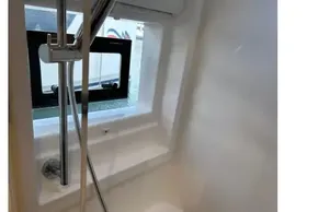 Modern shower area in 2022 Leopard 42 yacht with sleek fixtures and window.
