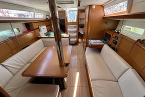 Interior of 2020 Jeanneau Sun Odyssey 389 sailboat with wood finish and seating area.
