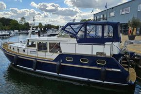 2005 Stevens 1200 Vlet boat docked at a marina under a partly cloudy sky.