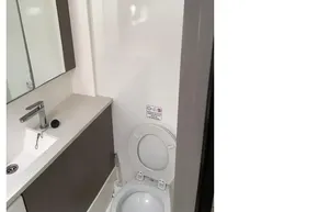Modern bathroom in 2022 Leopard 45 yacht with sink, mirror, and toilet.