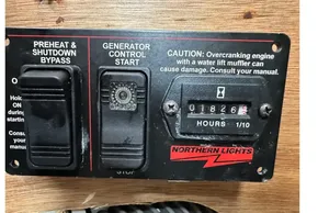 Control panel of a 2023 Beneteau Oceanis 51.1 with generator hour meter and caution label.