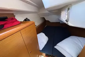 Cozy cabin interior of 2020 Jeanneau Sun Odyssey 389 sailboat with wooden cabinetry.